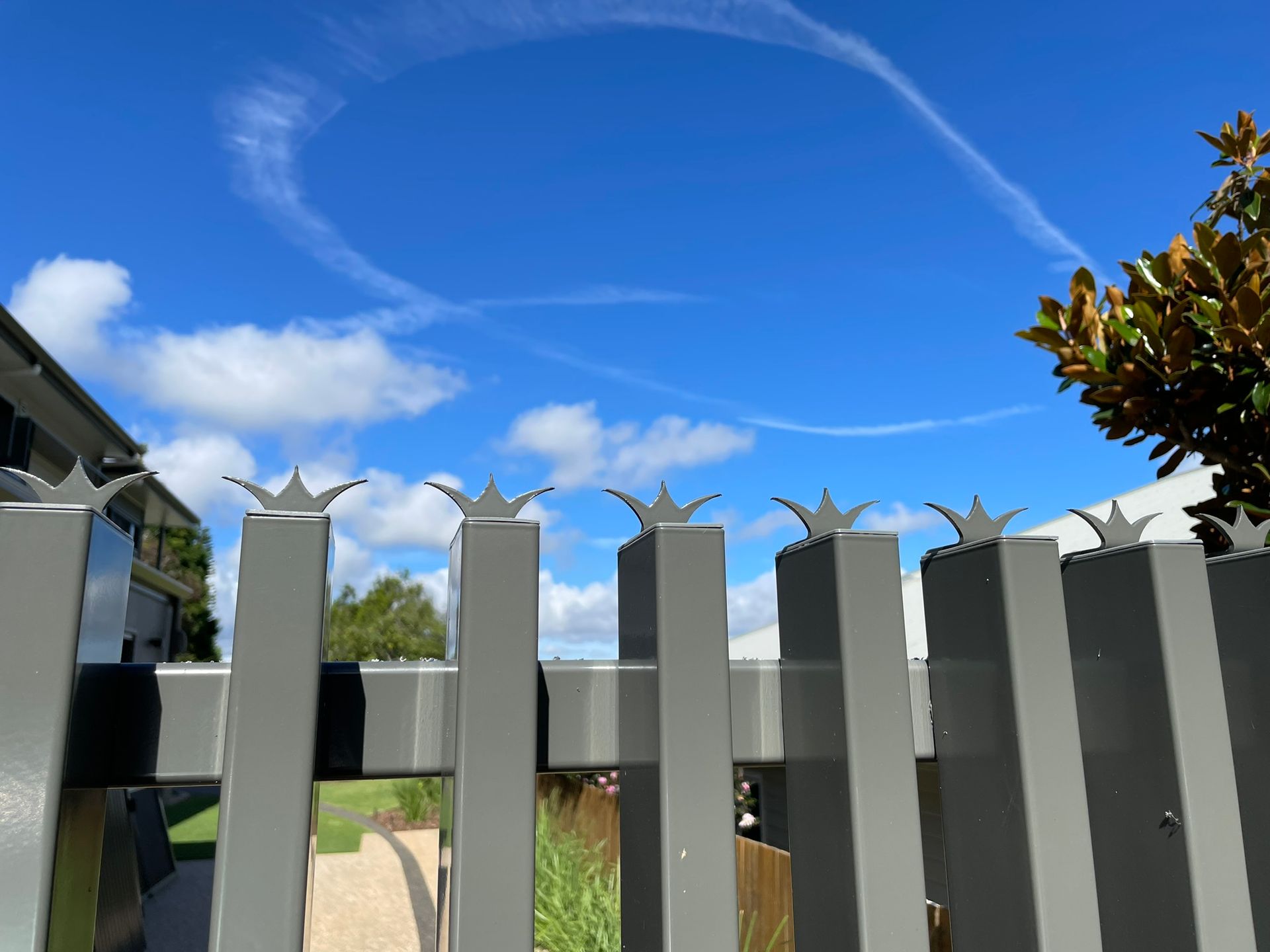 A fence with a blue sky in the background