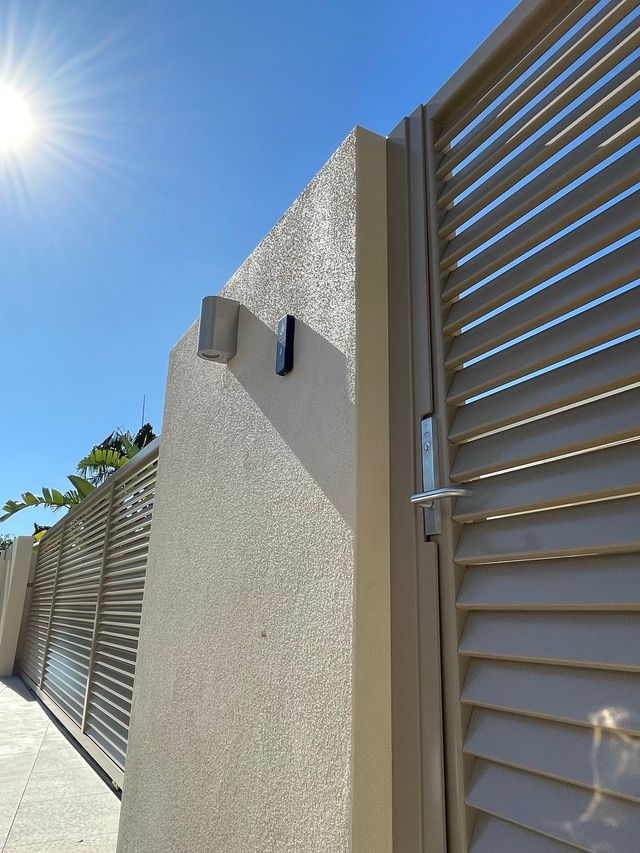 A close up of a gate with the sun shining through it.