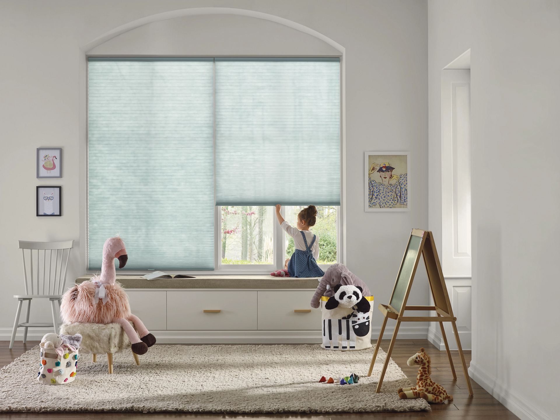 Child sitting by a window with Hunter Douglas Applause® Honeycomb Shades, showcasing energy-efficient window treatments from Barrows Custom Window Treatments in Eastern Massachusetts.