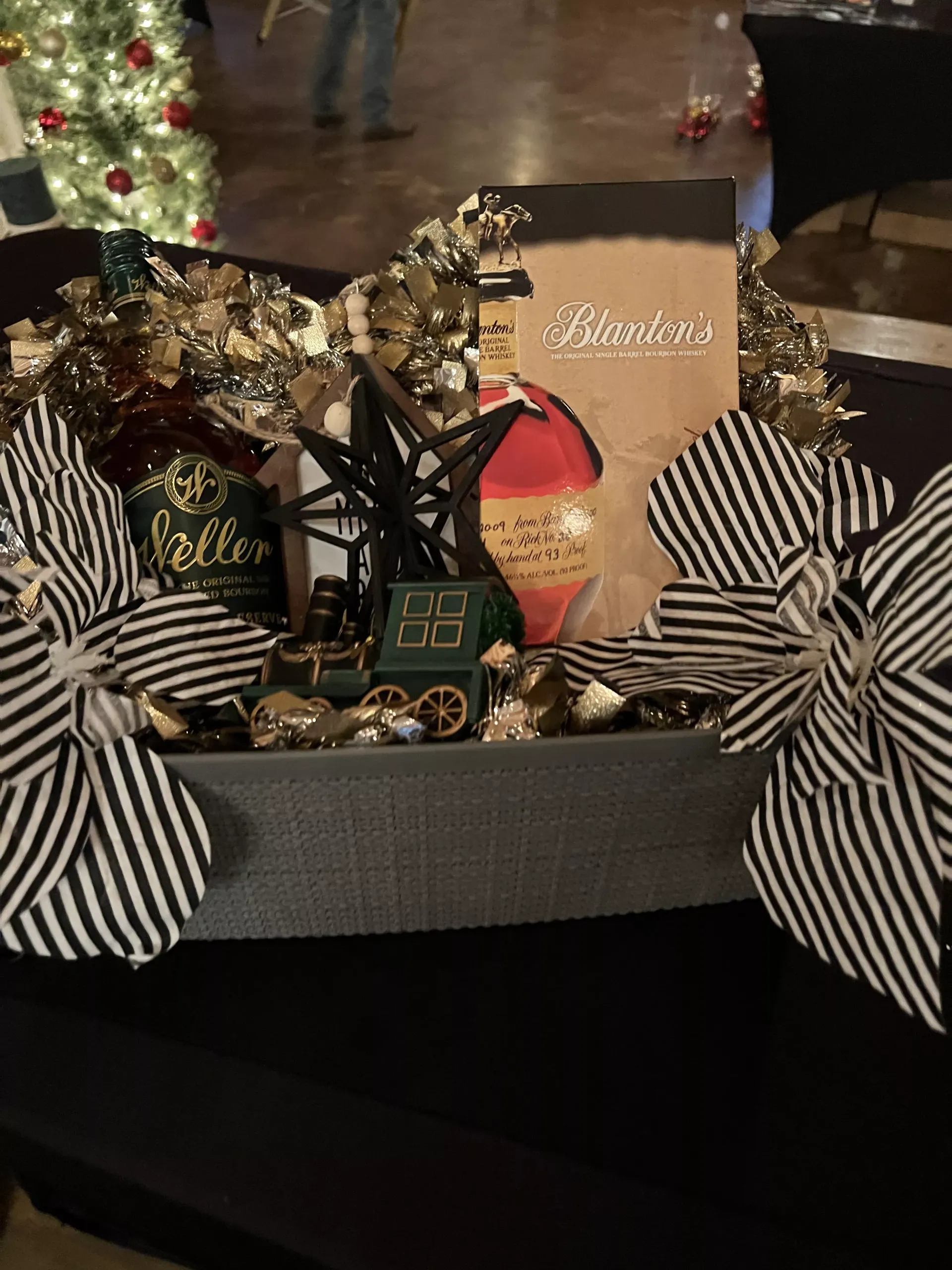 Holiday gift basket with striped bows, ornaments, and festive decorations on a table