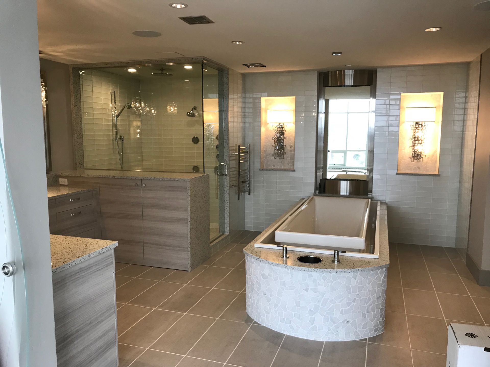 Modern spa bathroom with soaking tub, glass shower, tile floors, and soft lighting