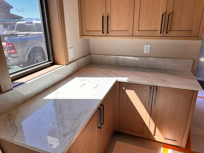 Corner kitchen countertop with wood cabinets and a window view outside
