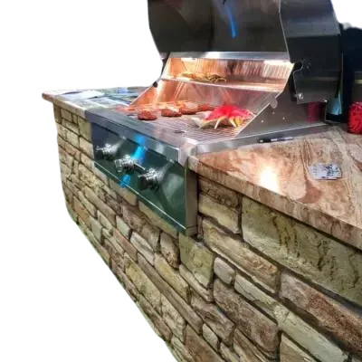 Outdoor grill built into a stone-covered island with food cooking on the grates.