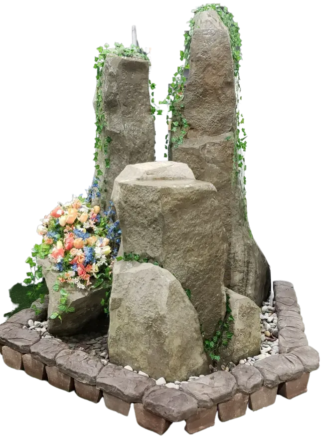 Rock fountain with faux ivy, flowers, and cobblestone base.