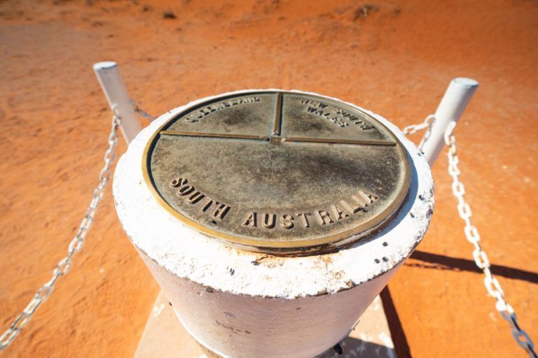 Metal marker on a white post with