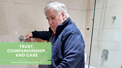 Man using a grab bar in a bathroom. Green text block reads 