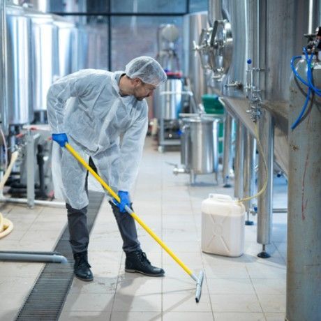Person squeegeeing a factory floor