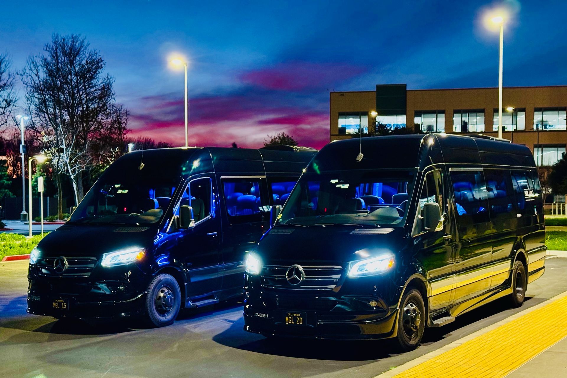 Black Mercedes Sprinter van parked on pavement. Has black wheels and a roof rack.