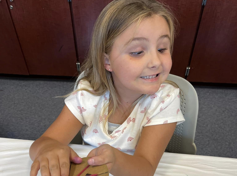 Girl attending a craft class.
