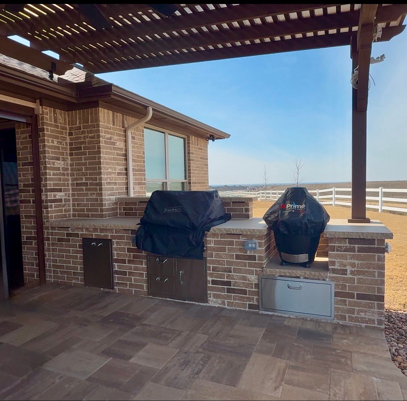 A large patio with a pergola and a lot of furniture.