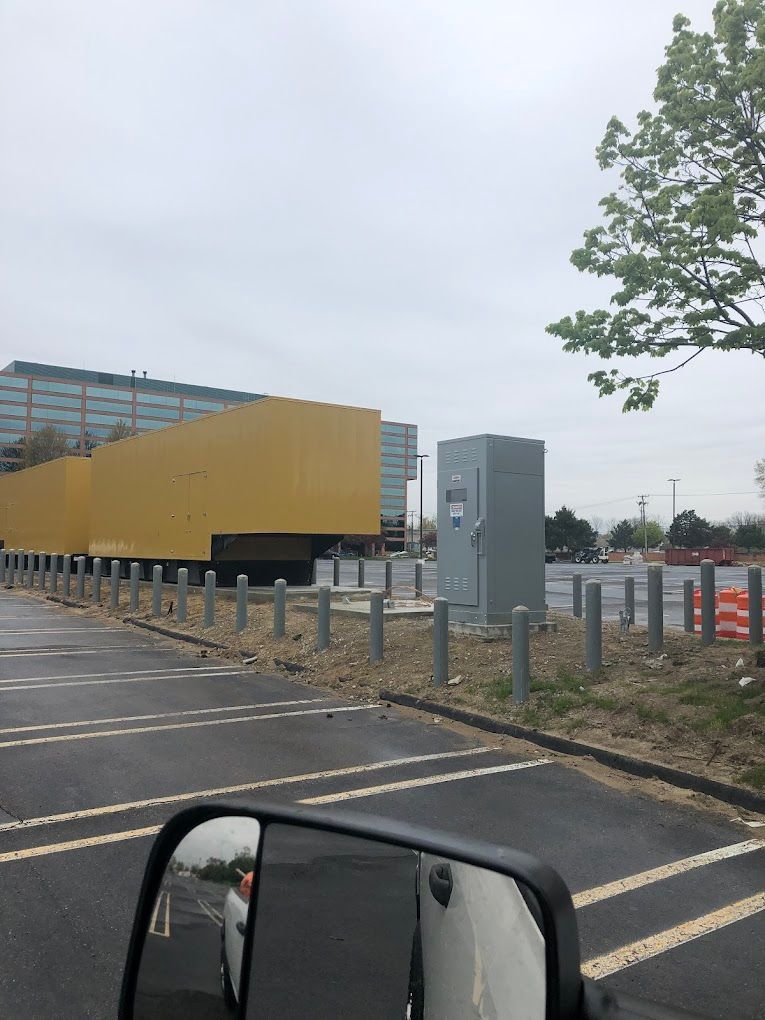A parking lot with a large yellow building in the background