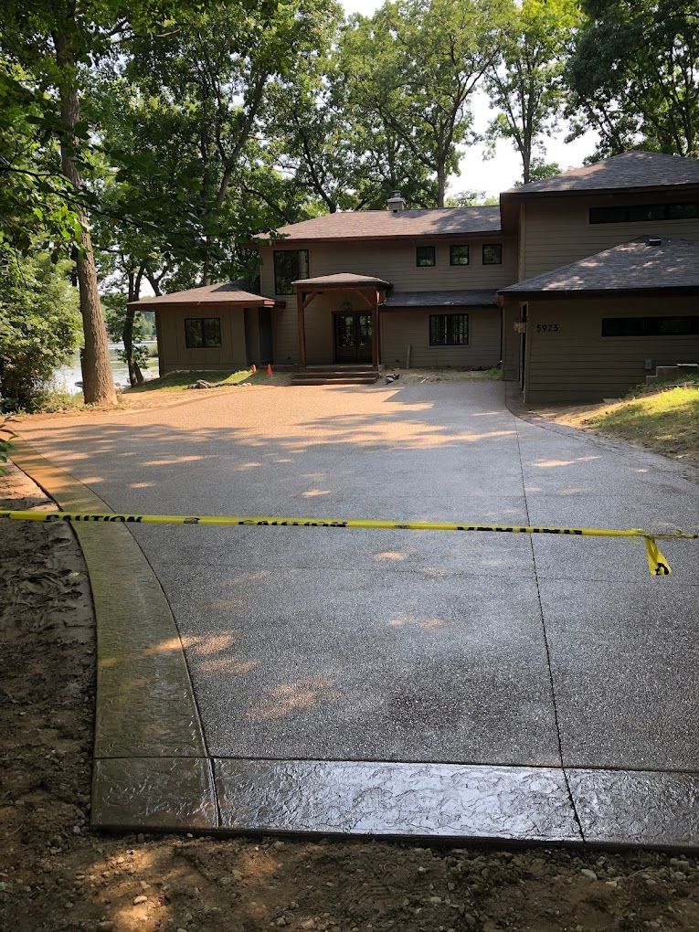 A large house with a large driveway leading to it.