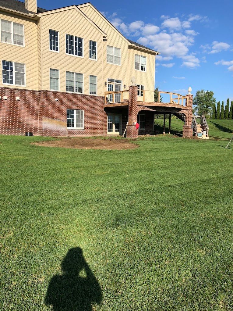 A large house with a large lawn in front of it.