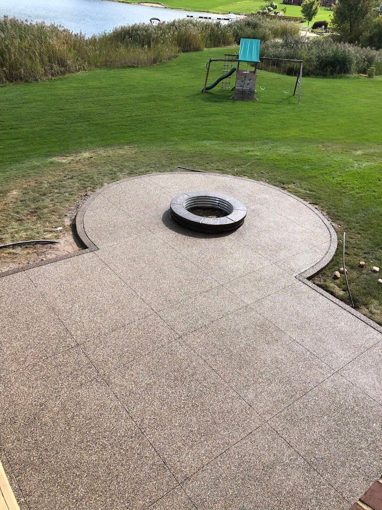 There is a fire pit in the middle of the patio.
