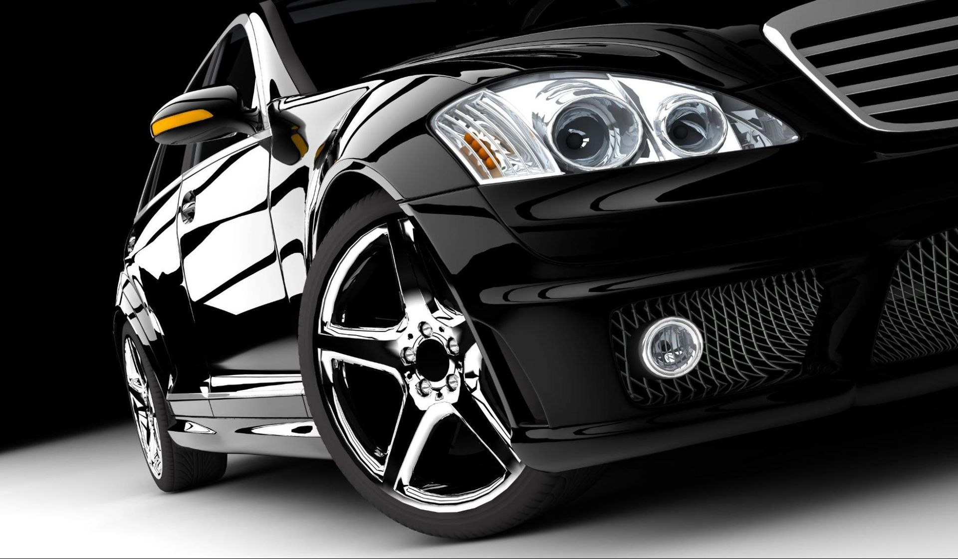 A close up of a black car with chrome wheels