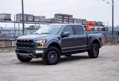 Gray pickup truck parked outdoors in an industrial lot