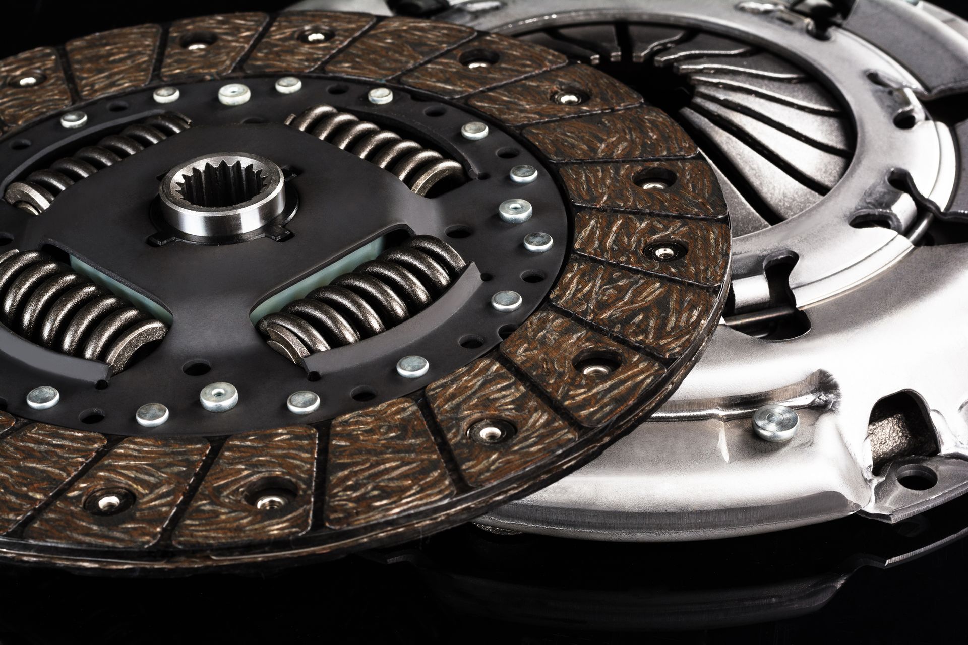 A close up of a clutch disc and clutch cover