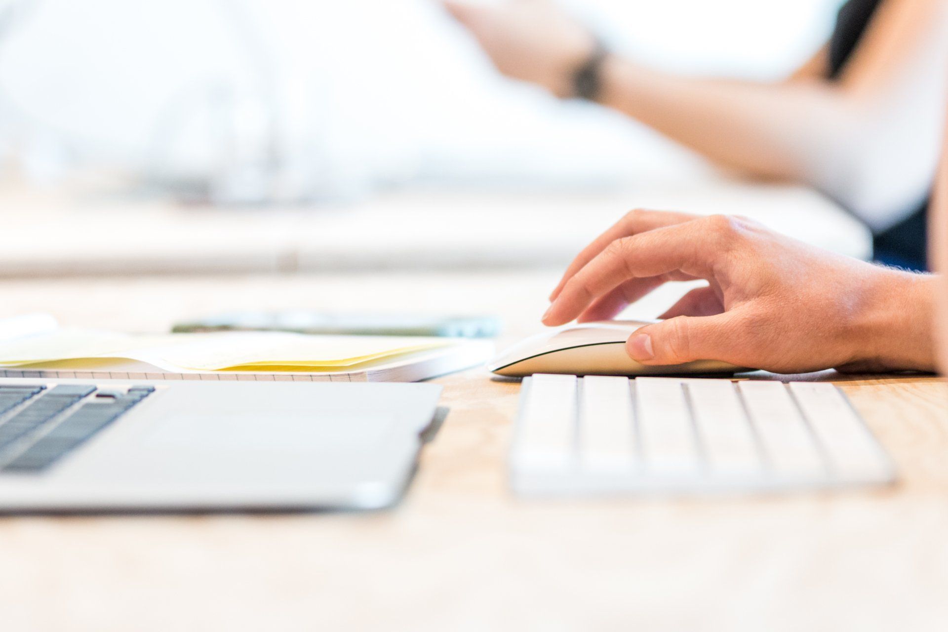 A Virtual Assistant is typing on a computer mouse and keyboard.