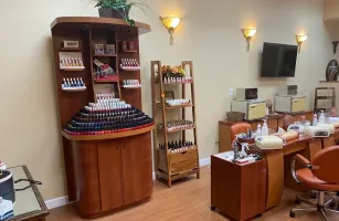 Salon interior with nail polish display, manicure stations, and warm wall lighting