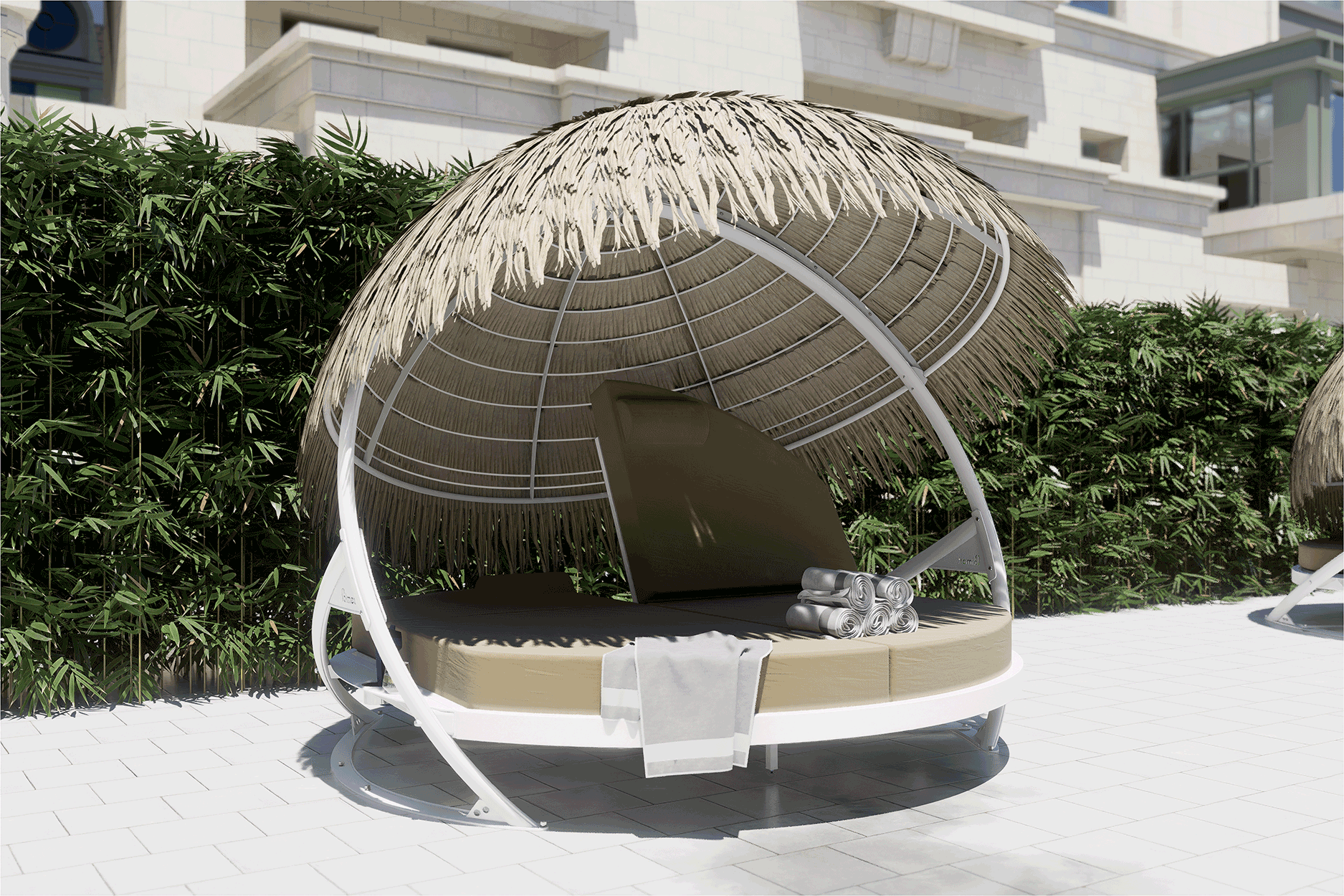 A round bed with a thatched roof is sitting in front of a building.