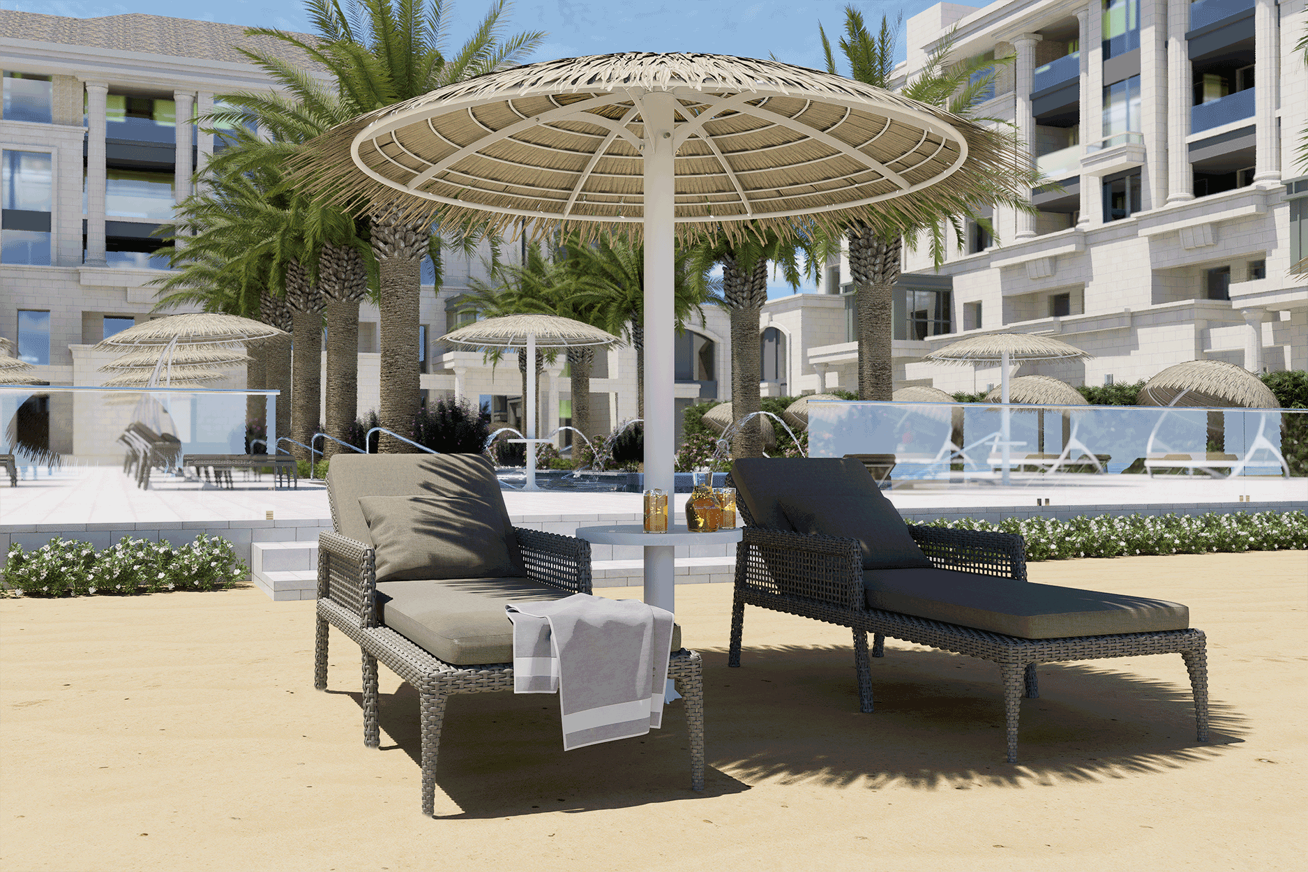 Two lounge chairs under an umbrella on the beach