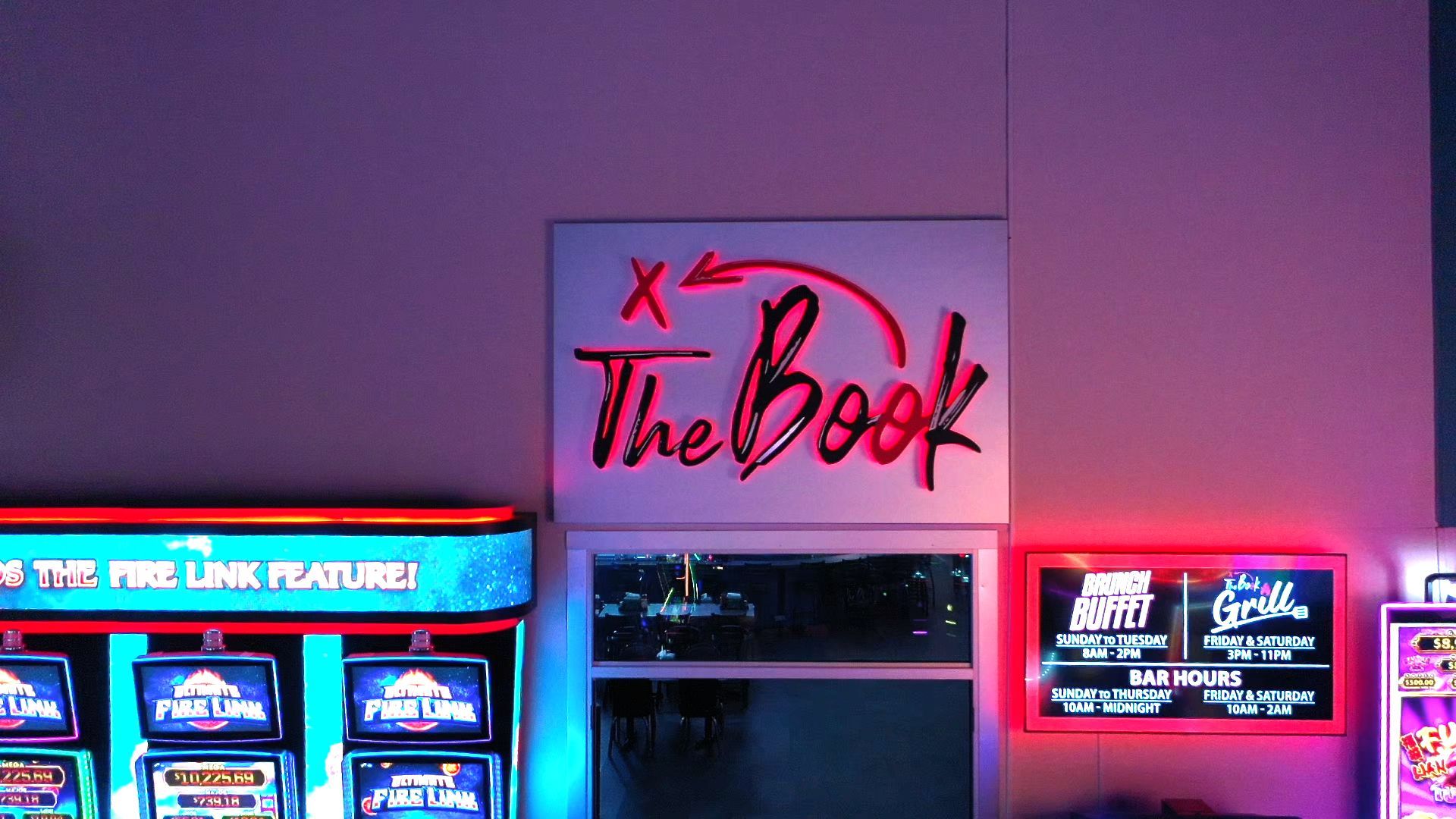 Casino interior with poker tables, gaming screens, and a red-lit St. Croix 3605 cabinet in the foreground