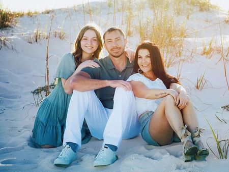 Sadie Kolves and her family sitting on sand dune