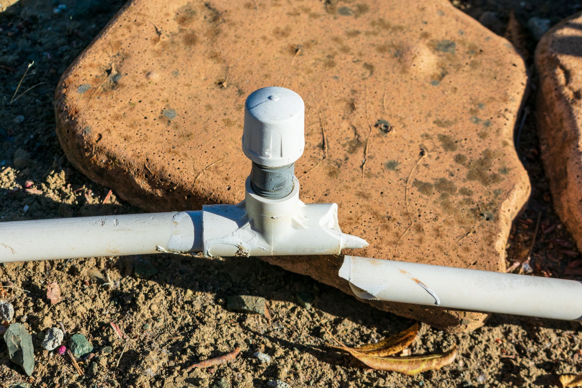 A damaged main water pipe to an outdoor sprinkler system