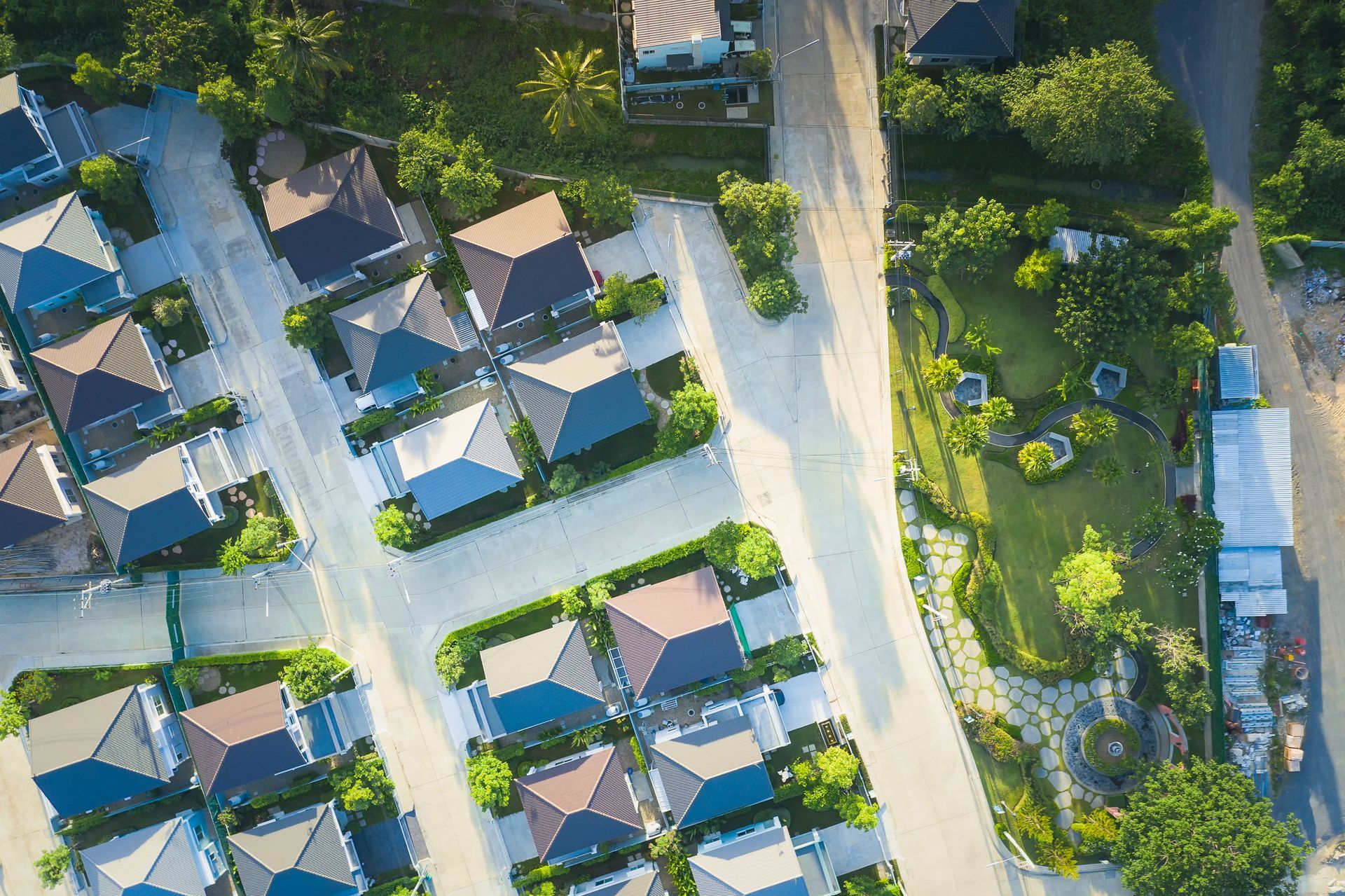 An aerial view of a residential area with lots of houses and trees.