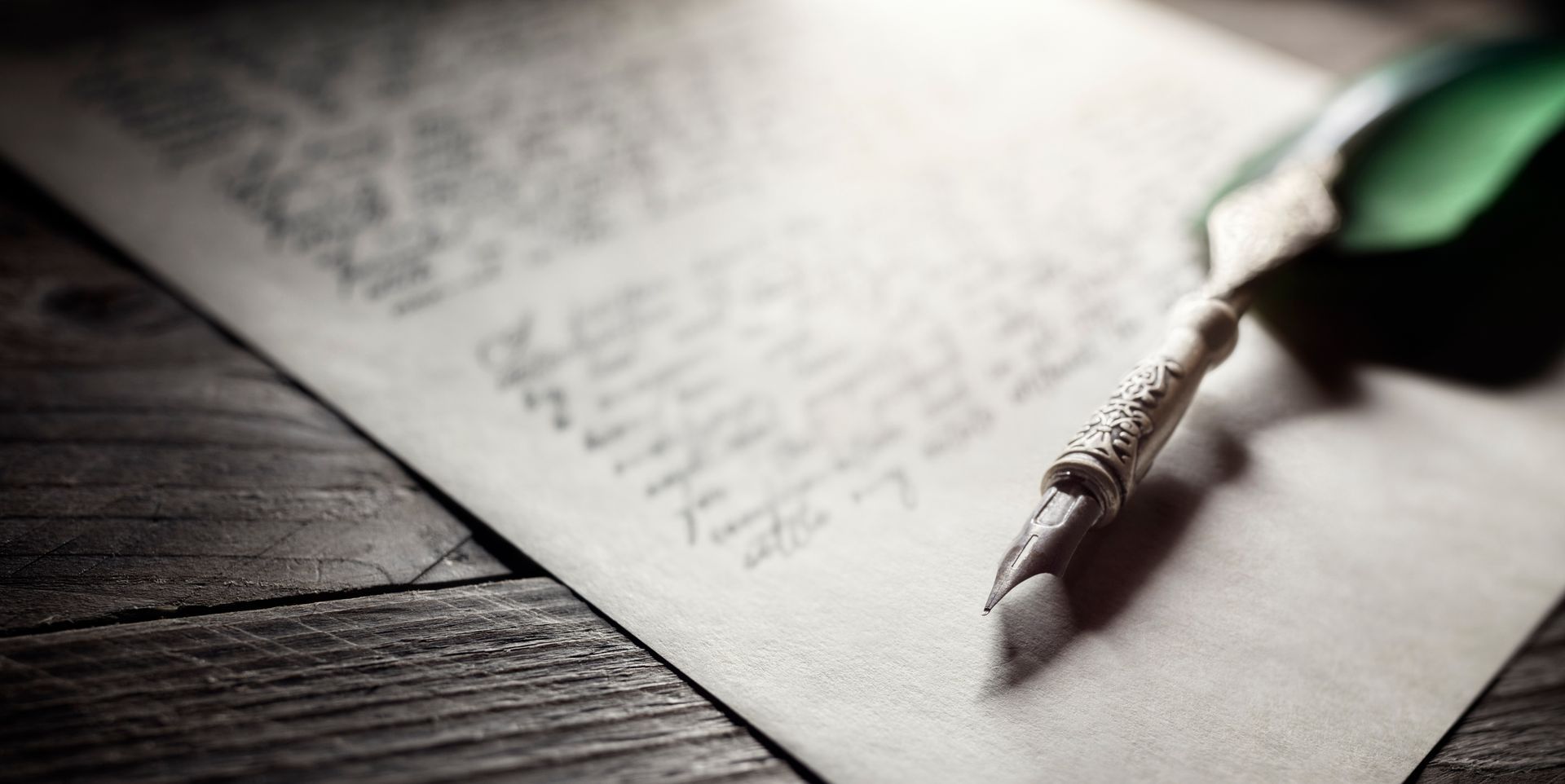 A fountain pen is sitting on top of a piece of paper.