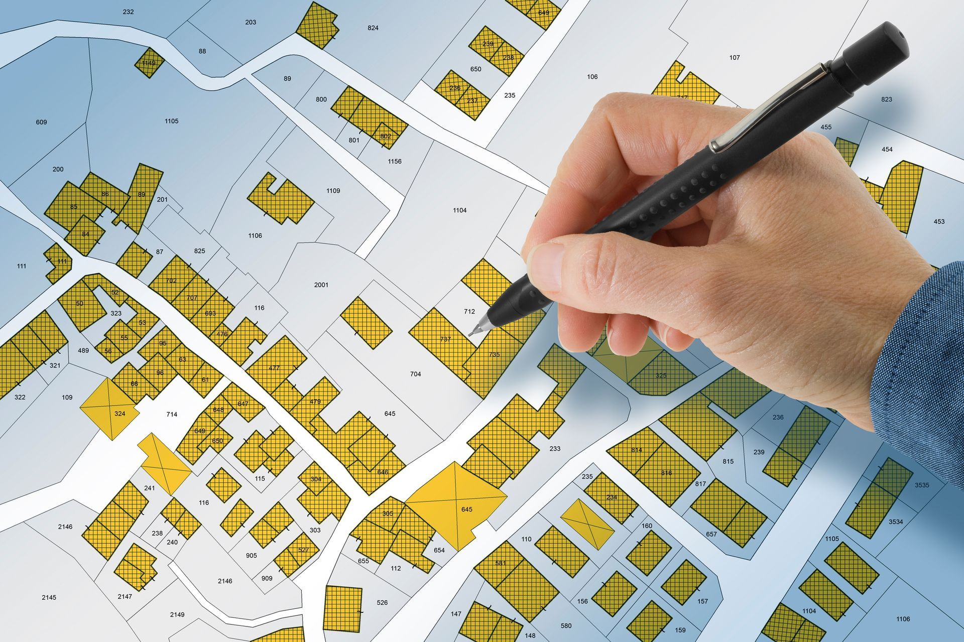 A person is writing on a map with a pen