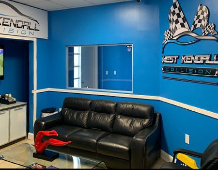 A waiting room with a couch and a sign that says kendall precision