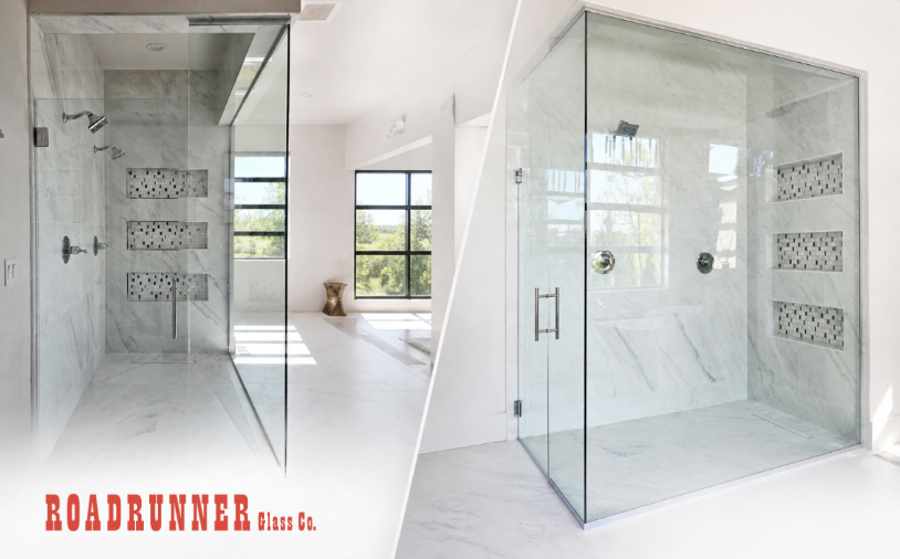 Glass frameless shower enclosures in a bright modern bathroom showroom with red branding and phone number