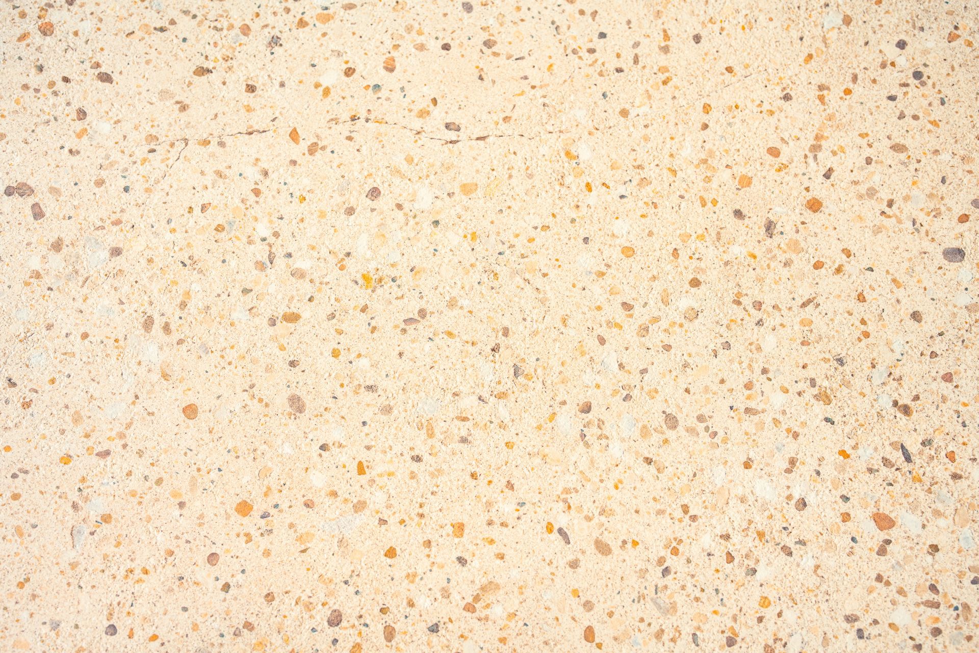 Beige speckled concrete surface.