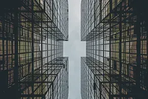 Looking up at a very tall building with a lot of windows.