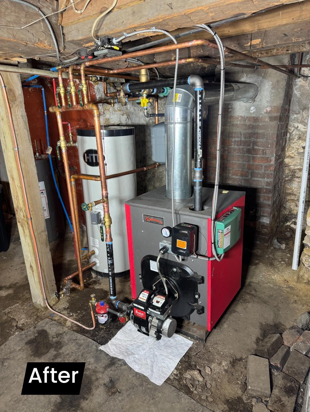 Basement utility area with a new boiler, water heater, pipes, and ductwork labeled “After”