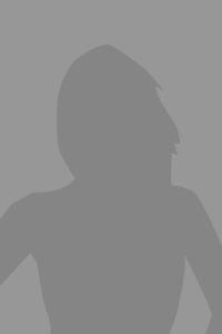 Silhouette of a person with long hair and arms at their sides against a gray background.