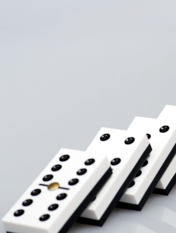 A row of white dominoes with black dots on them