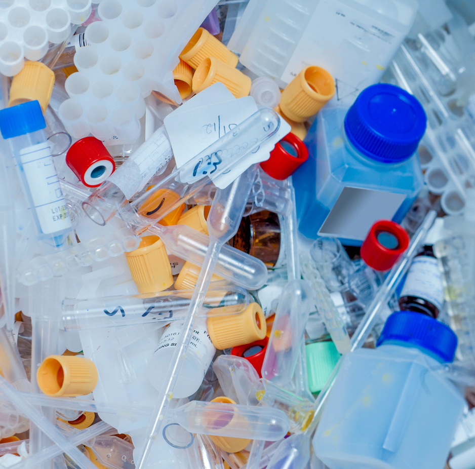 A pile of medical supplies including a syringe with the number 23 on it