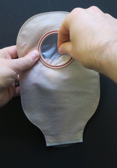A person is holding a bag with a hole in it