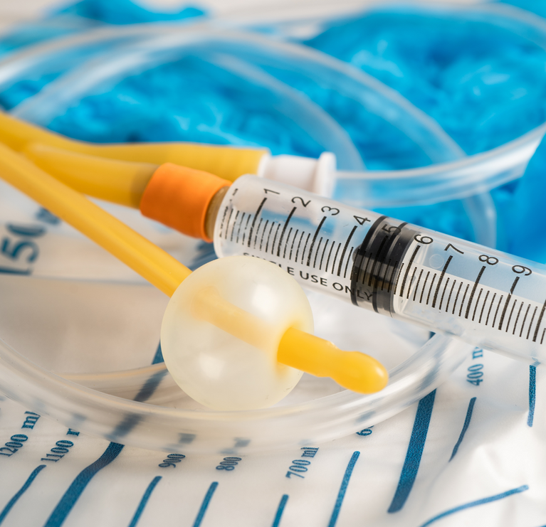 A syringe is sitting on top of a urine bag