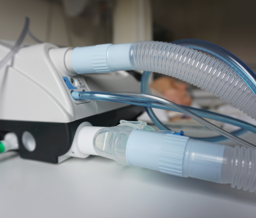 A close up of a medical device with a hose attached to it
