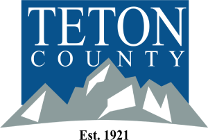 Teton County logo with blue background, white text, gray mountains, and “Est. 1921” below