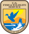 U.S. Fish and Wildlife Service seal with blue bird, fish, sun, and Department of the Interior text