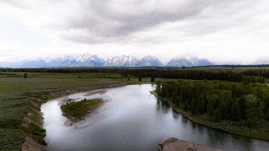 The Snake River winding through Jackson Hole with the Teton mountains in summer