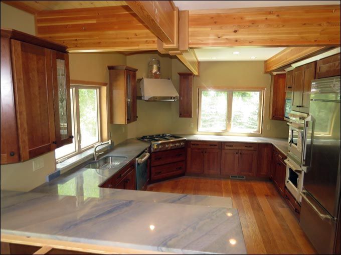 A kitchen with stainless steel appliances and wooden cabinets