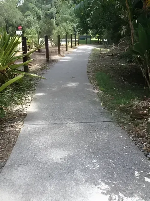 A Concrete Walkway In A Park With Trees On Both Sides — S & K Gallaway Concreting In West Mackay, QLD