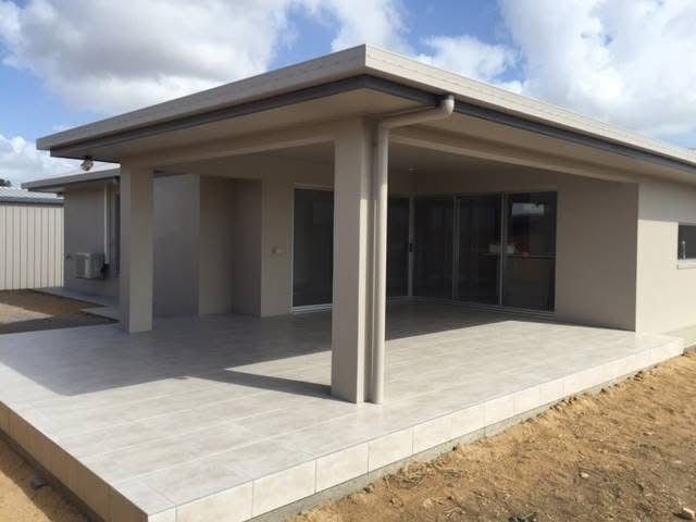 A Concrete Driveway Is Being Built In Front Of A House — S & K Gallaway Concreting In West Mackay, QLD