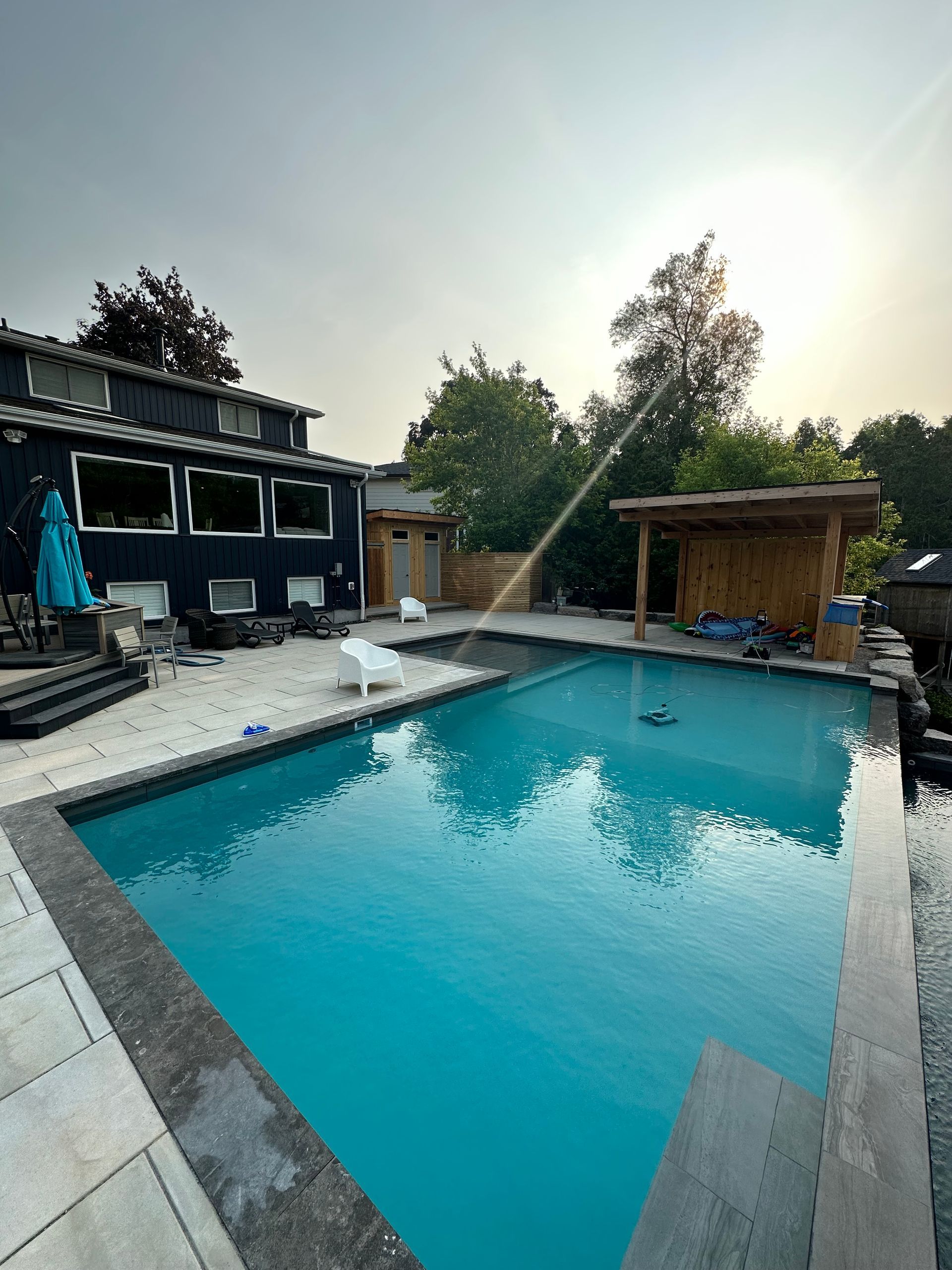A large swimming pool in the backyard of a house