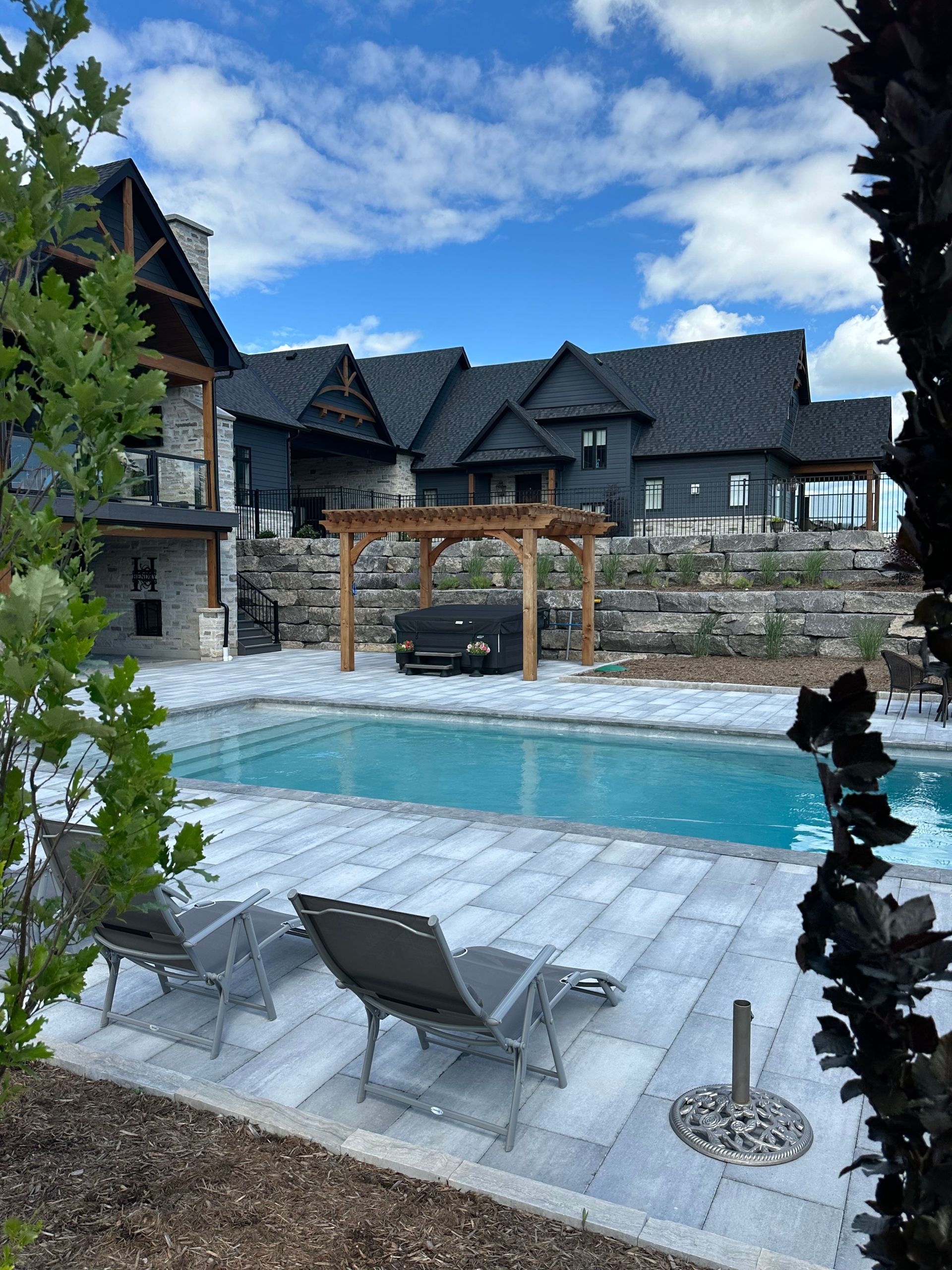 A large house with a large swimming pool in front of it.